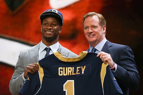 Todd Gurley of the Georgia Bulldogs holds up a jersey with NFL Commissioner Roger Goodell after being picked #10 overall by the St. Louis Rams
