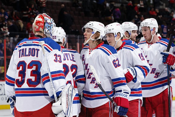 Cam Talbot #33 of the New York Rangers celebrates with team mates Carl Hagelin #62