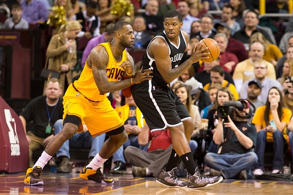 LeBron James #23 of the Cleveland Cavaliers guards Joe Johnson #7 of the Brooklyn Nets