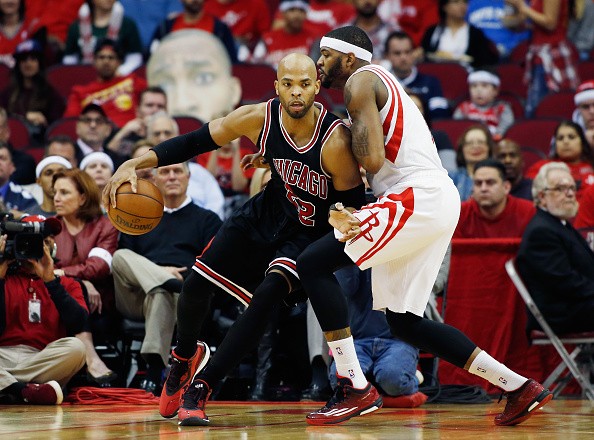 Taj Gibson #22 of the Chicago Bulls drives with the basketball as Josh Smith #5 of the Houston Rockets defends
