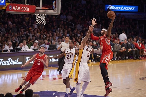 Josh Smith #5 of the Houston Rockets shoots over Carlos Boozer #5 of the Los Angeles Lakers