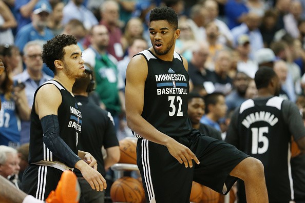Tyus Jones #1 and Karl-Anthony Towns #32 of the Minnesota Timberwolves 