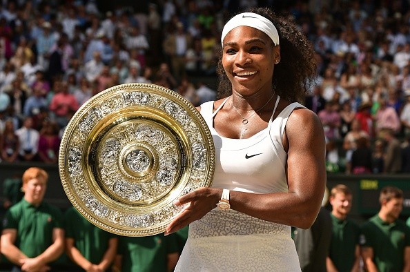 US player Serena Williams celebrates with the winner's trophy, the Venus Rosewater Dish, after her women's singles final victory over Spain's Garbine Muguruza