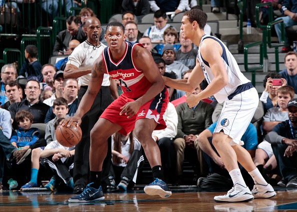 Kevin Seraphin #13 of the Washington Wizards posts up against Dwight Powell #8 of the Dallas Mavericks