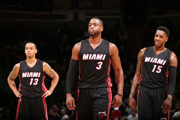 Shabazz Napier #13, Dwyane Wade #3 and Mario Chalmers #15 of the Miami Heat 