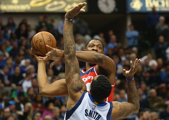 Kevin Seraphin #13 of the Washington Wizards takes a shot against Greg Smith #4 of the Dallas Mavericks