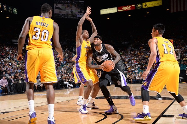 DeMarcus Cousins #15 of the Sacramento Kings handles the basketball against Ed Davis #21 of the Los Angeles Lakers