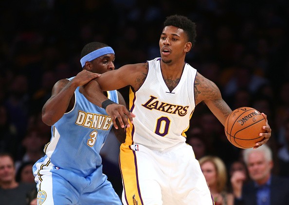 Nick Young #0 of the Los Angeles Lakers gets his elbow up on Ty Lawson #3 of the Denver Nuggets 