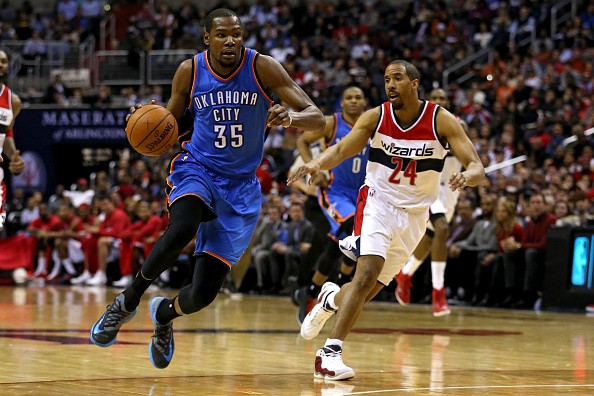 Kevin Durant #35 of the Oklahoma City Thunder dribbles past Andre Miller #24 of the Washington Wizards