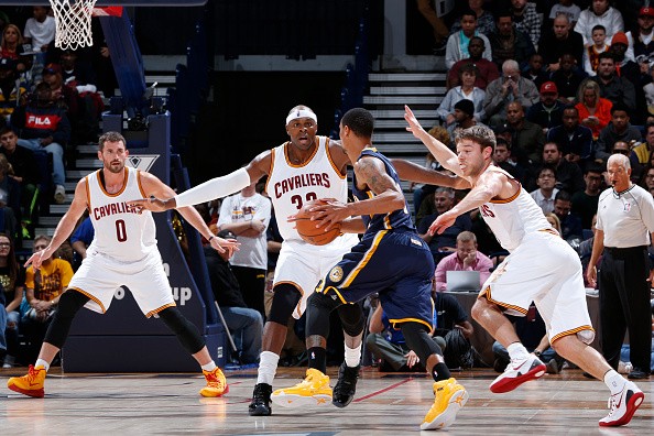 Brendan Haywood #33, Matthew Dellavedova #8 and Kevin Love #0 of the Cleveland Cavaliers 