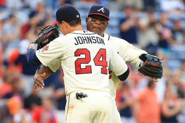 Kelly Johnson #24 celebrates with Juan Uribe #2 of the Atlanta Braves after beating New York Mets 