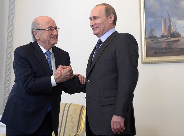 Russian President Vladimir Putin (R) greets FIFA President Joseph Blatter 