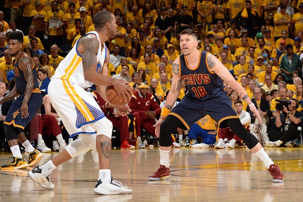 Andre Iguodala #9 of the Golden State Warriors handles the ball against Mike MIller #18 of the Cleveland Cavaliers