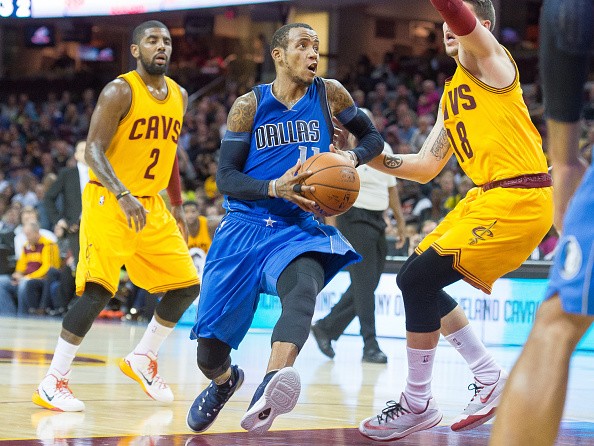 Monta Ellis #11 of the Dallas Mavericks drives past Kyrie Irving #2 and Mike Miller #18 of the Cleveland Cavaliers