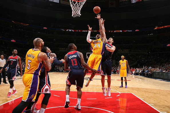 Kobe Bryant #24 of the Los Angeles Lakers shoots against Kris Humphries #43 and Kevin Seraphin #13 of the Washington Wizards