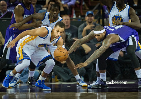 The Golden State Warriors' Stephen Curry (30) steals the ball from the Sacramento Kings' DeMarcus Cousins 