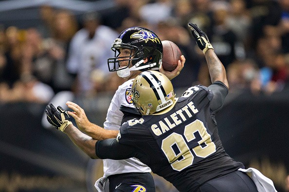 Junior Galette #93 of the New Orleans Saints hits Joe Flacco #5 of the Baltimore Ravens