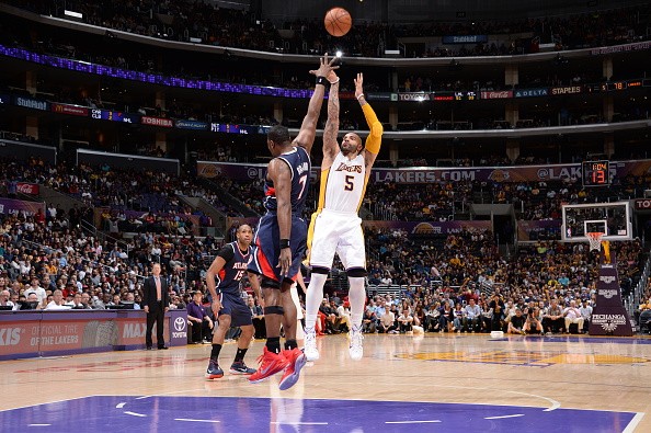 Carlos Boozer #5 of the Los Angeles Lakers shoots against Elton Brand #7 of the Atlanta Hawks 