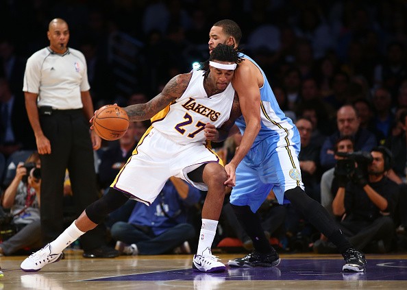 Jordan Hill #27 of the Los Angeles Lakers posts up against JaVale McGee #34 of the Denver Nuggets