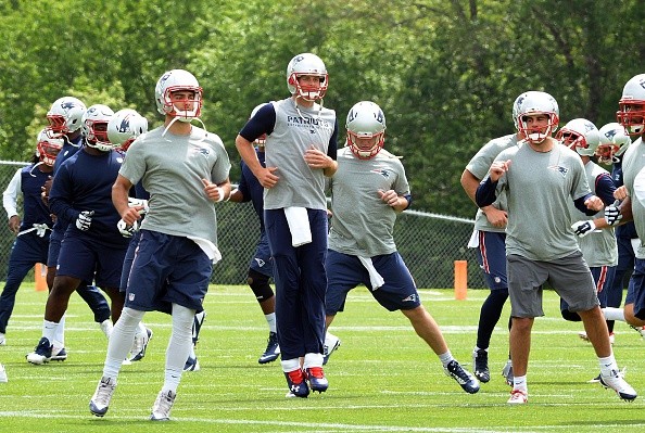Tom Brady #12 of the New England Patriots, (C) and back up quarterback Jimmy Garappolo 