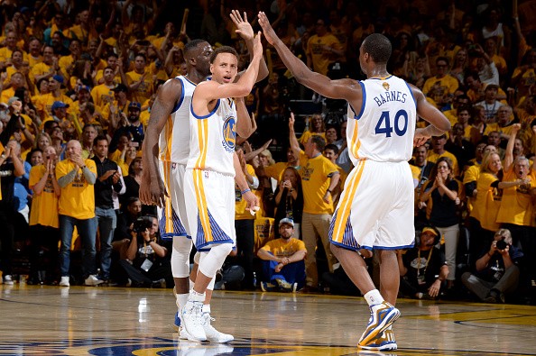 Draymond Green #23, Stephen Curry #30 and Harrison Barnes #40 of the Golden State Warriors