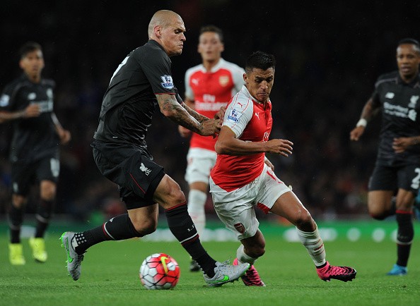 Alexis Sanchez of Arsenal takes on Martin Skrtel of Liverpool