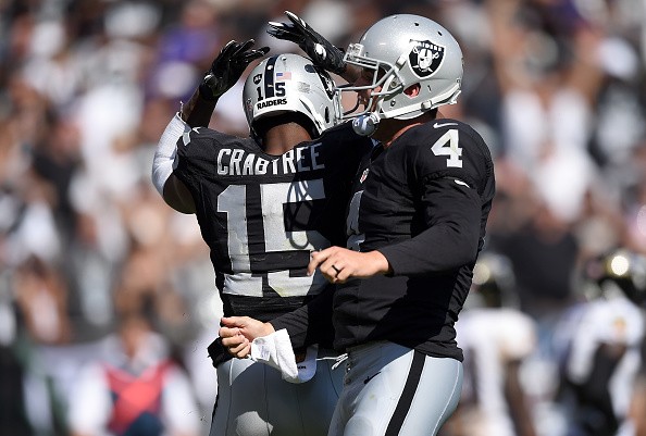 Michael Crabtree #15 and Derek Carr #4 of the Oakland Raiders