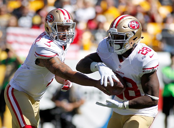 Colin Kaepernick #7 hands off to Carlos Hyde #28 of the San Francisco 49ers