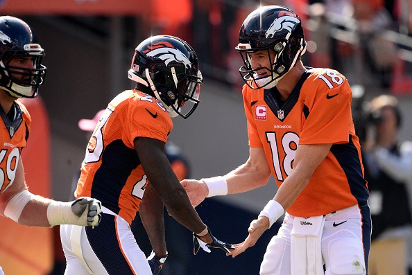 Ronnie Hillman (23) of the Denver Broncos celebrates with Peyton Manning 