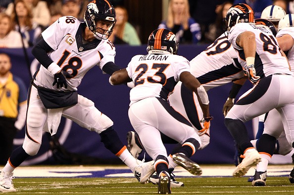 Peyton Manning #18 hands off to Ronnie Hillman #23 of the Denver Broncos