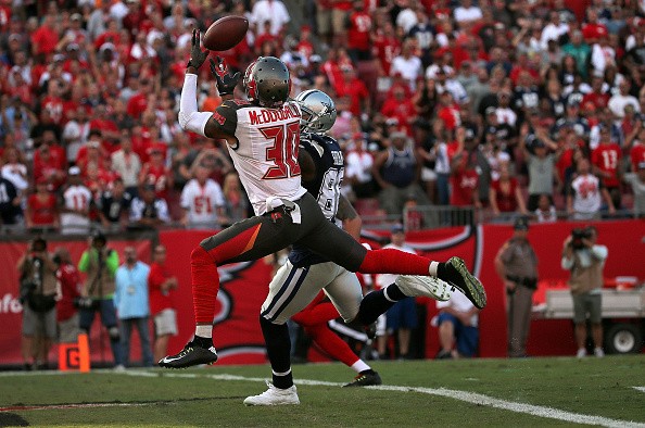 Dez Bryant #88 of the Dallas Cowboys, Bradley McDougald #30 of the Tampa Bay Buccaneers