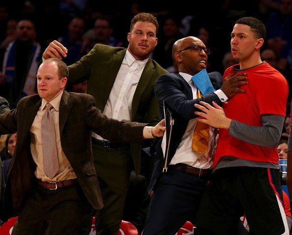Austin Rivers #25 of the Los Angeles Clippers is held back by Sam Cassell and Blake Griffin 