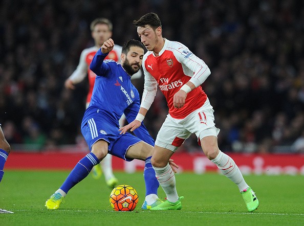 Mesut Ozil of Arsenal takes on Cesc Fabgreas of Chelsea 