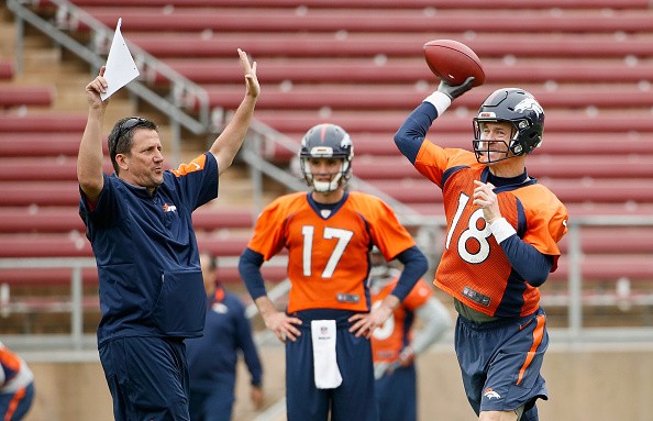 Brock Osweiler #17 watches Peyton Manning #18 of the Denver Broncos 