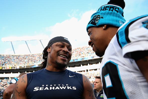 Ted Ginn #19 of the Carolina Panthers and Marshawn Lynch #24 of the Seattle Seahawks