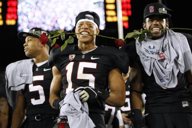 Stanford Cardinal cornerback Usua Amanam bites on roses after his team defeated the UCLA Bruins 27-24 to advance to the Rose Bowl