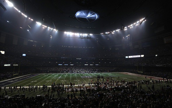 The Superdome field is covered in partial darkness during a power outage 